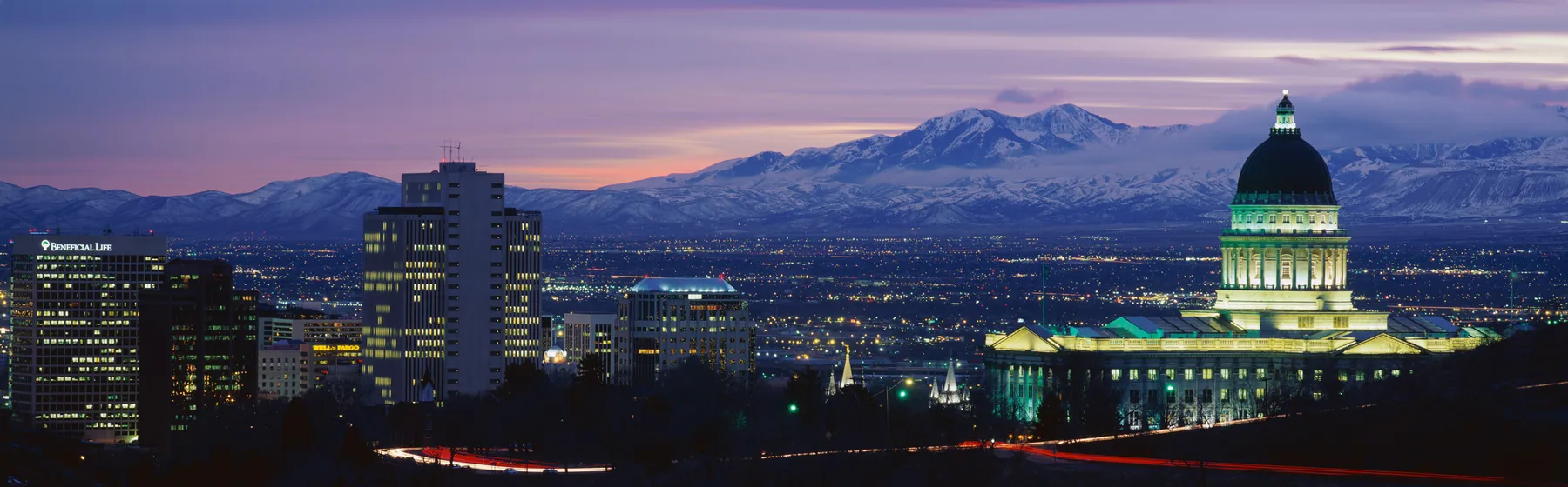 Utah State Capitol overlooking Salt Lake City and snow-covered mountains at dusk
